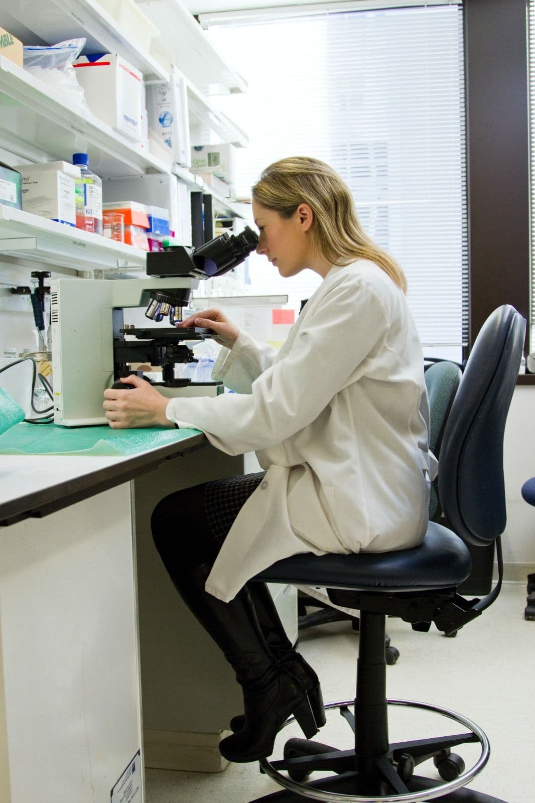 Female scientist looking through a microscope